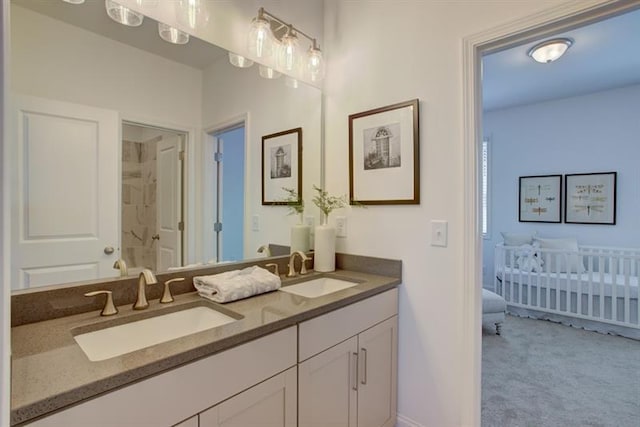 bathroom featuring double vanity, a shower, and a sink