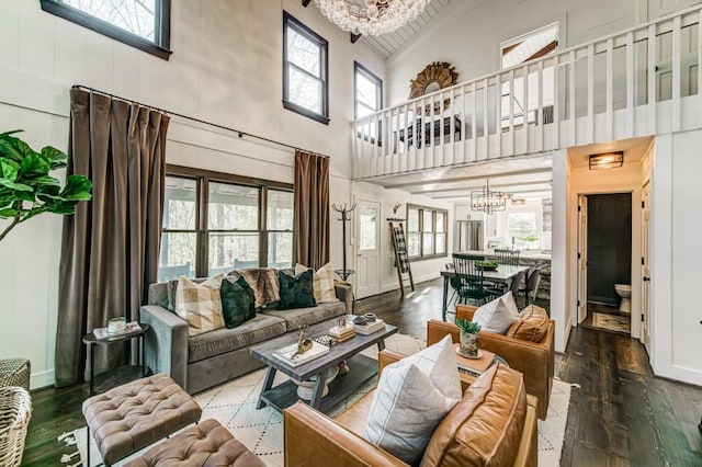 242 Buckskull Hollow Dr, Jasper, GA 30143 - living area featuring a chandelier, high vaulted ceiling, hardwood / wood-style floors, and baseboards