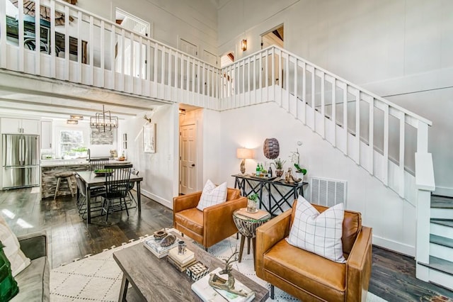 242 Buckskull Hollow Dr, Jasper, GA 30143 - living room with stairway, wood finished floors, a chandelier, and a towering ceiling