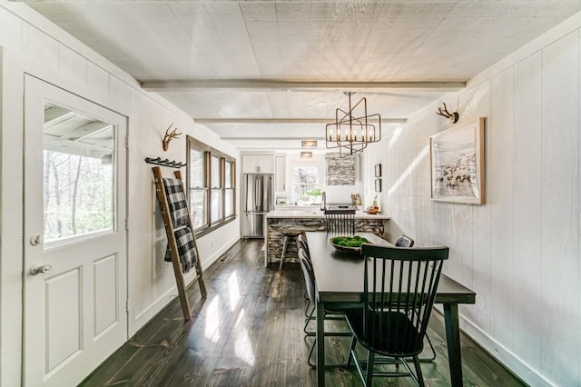 242 Buckskull Hollow Dr, Jasper, GA 30143 - dining area with dark wood-style flooring, beamed ceiling, a chandelier, baseboards, and wood walls