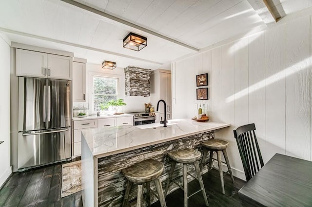 242 Buckskull Hollow Dr, Jasper, GA 30143 - kitchen featuring freestanding refrigerator, a sink, dark wood-style floors, light stone counters, and a kitchen breakfast bar