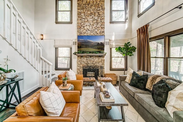 242 Buckskull Hollow Dr, Jasper, GA 30143 - living room featuring a high ceiling, a stone fireplace, and stairway