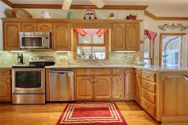 kitchen featuring decorative backsplash, a wealth of natural light, sink, and stainless steel appliances