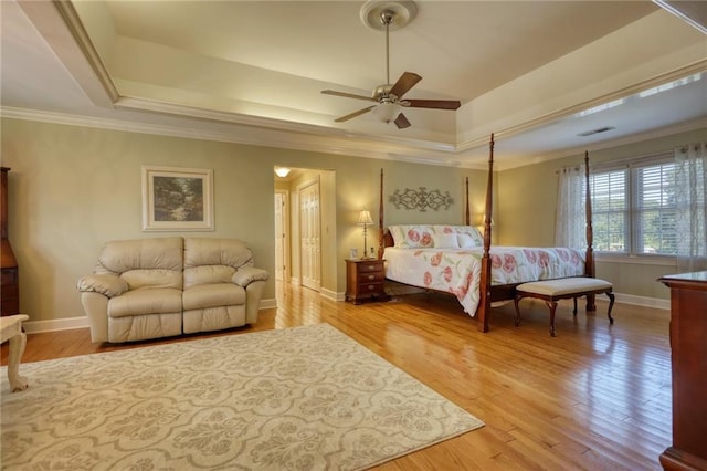 bedroom featuring a tray ceiling, ceiling fan, and crown molding