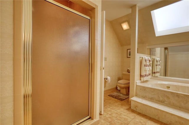 bathroom featuring vaulted ceiling with skylight, tile patterned flooring, toilet, and independent shower and bath