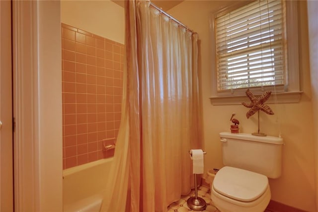 bathroom featuring toilet and shower / bath combo with shower curtain