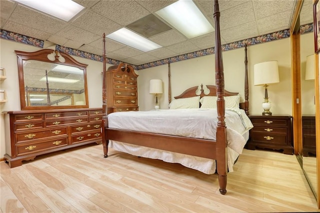 bedroom featuring a paneled ceiling and hardwood / wood-style flooring