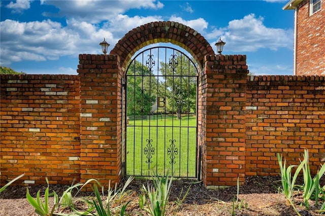 view of gate featuring a yard