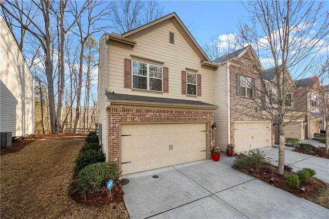 view of front of property featuring concrete driveway, a garage, and brick siding