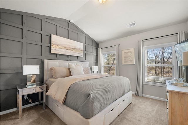 bedroom featuring light carpet, visible vents, baseboards, and lofted ceiling