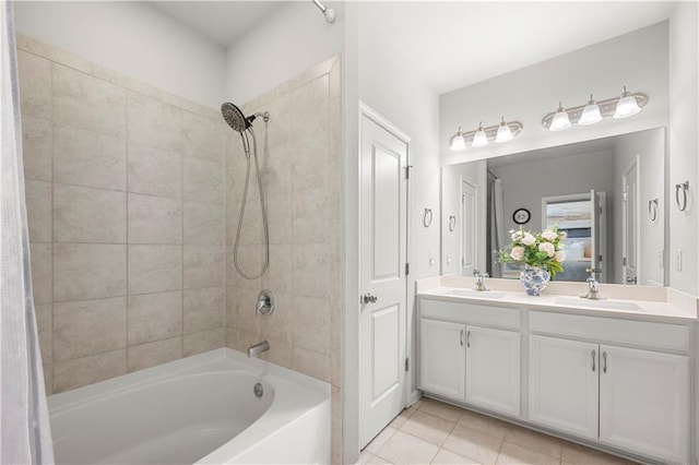 bathroom with a sink, shower / washtub combination, double vanity, and tile patterned flooring