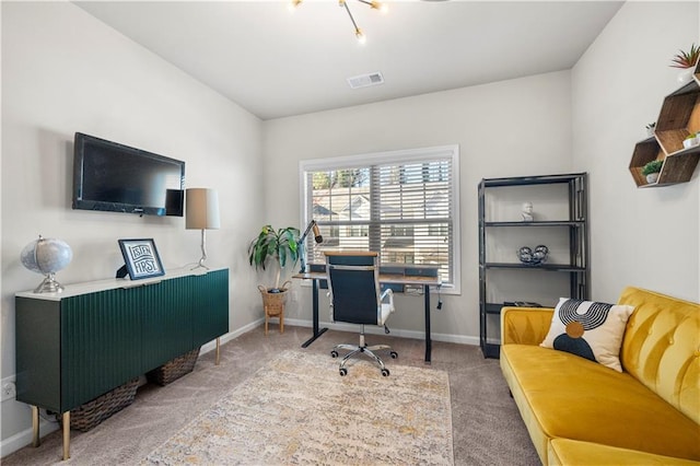 carpeted office with visible vents and baseboards