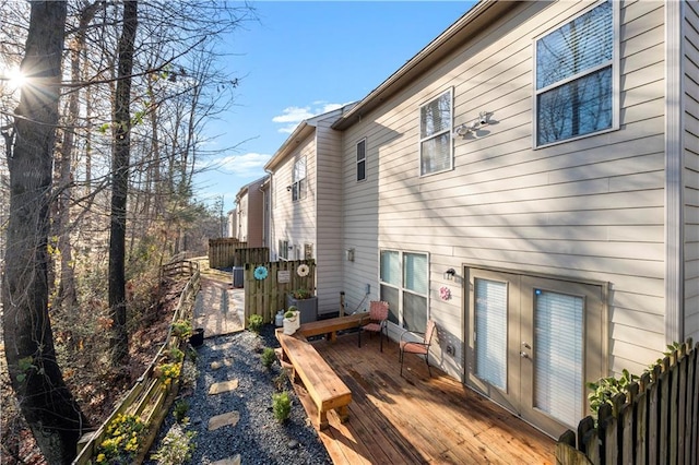 back of property featuring a wooden deck and fence