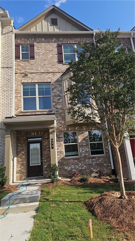 539 Fundao Ln # 28, Lawrenceville, GA 30046 - view of front of property featuring brick siding, board and batten siding, and a front yard