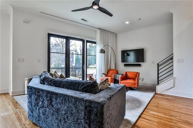 living room with ceiling fan and light hardwood / wood-style floors