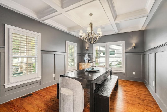 dining room with beam ceiling, hardwood / wood-style floors, and coffered ceiling