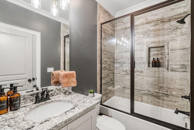 full bathroom featuring vanity, toilet, and shower / bath combination with glass door