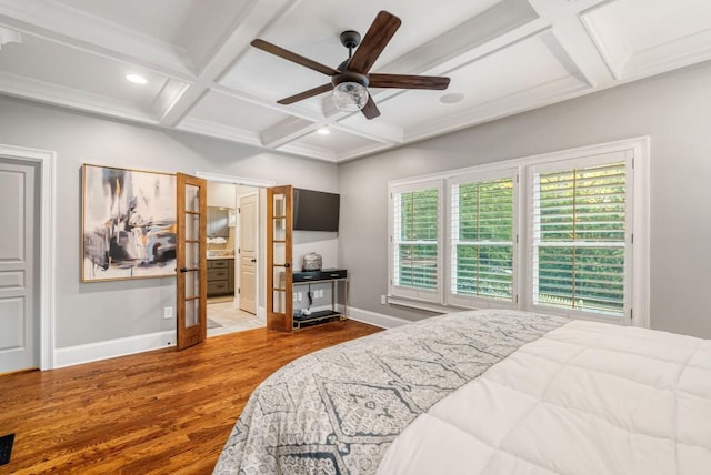 bedroom with coffered ceiling, multiple windows, wood-type flooring, and ceiling fan