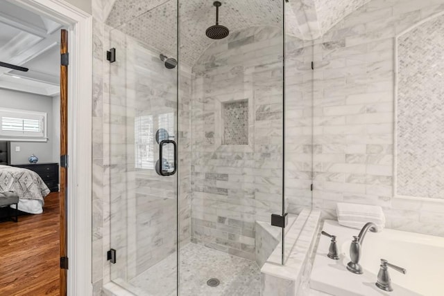 bathroom with hardwood / wood-style flooring, independent shower and bath, lofted ceiling, and tile walls