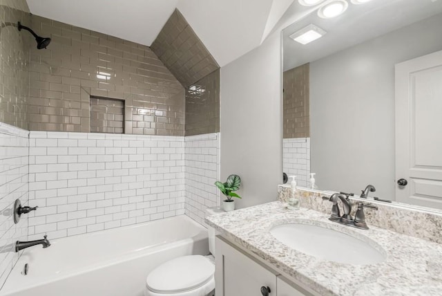 full bathroom with vanity, toilet, and tiled shower / bath combo