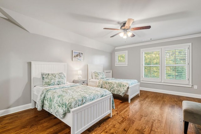 bedroom featuring ceiling fan, lofted ceiling, wood-type flooring, and ornamental molding