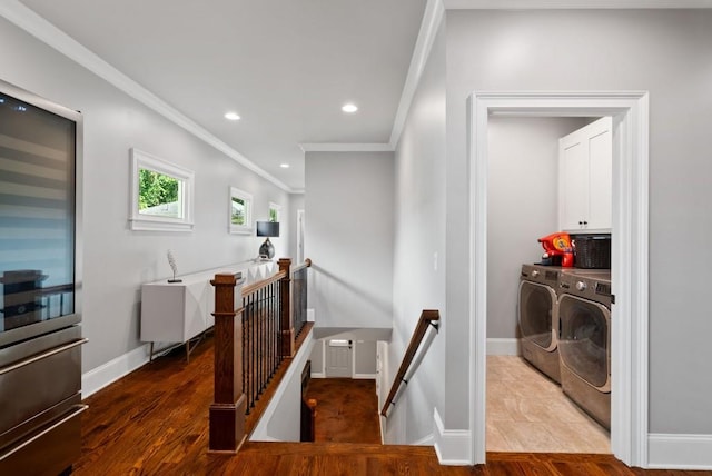 corridor with crown molding, hardwood / wood-style flooring, and separate washer and dryer