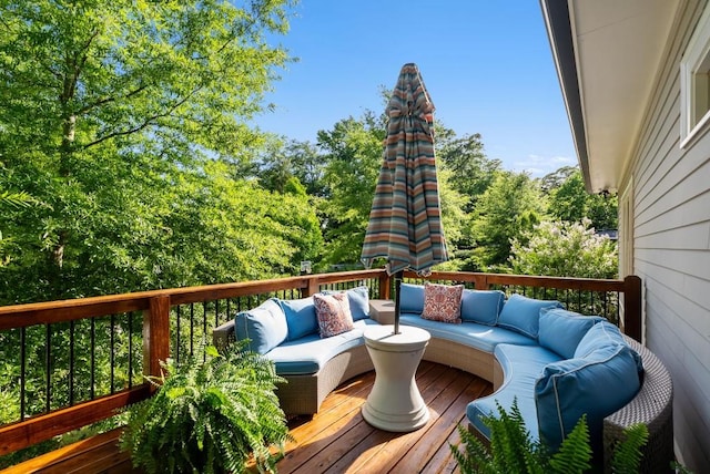 wooden terrace with an outdoor living space