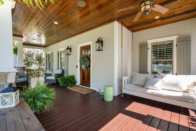 wooden deck featuring an outdoor hangout area and ceiling fan