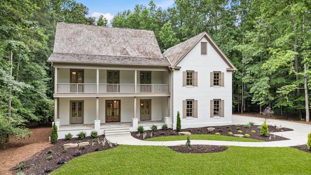 1960 Drummond Pond Rd, Milton, GA 30004 - view of front of home featuring a balcony, stucco siding, covered porch, and a front lawn