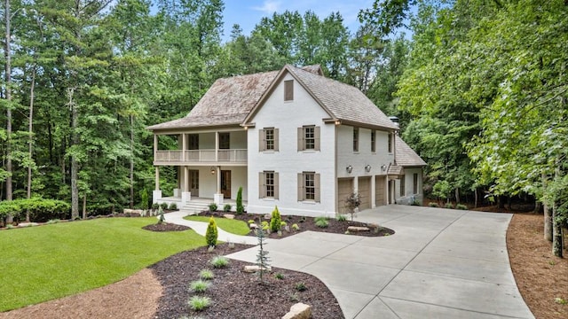 1960 Drummond Pond Rd, Milton, GA 30004 - view of front of property featuring a balcony, concrete driveway, covered porch, a front lawn, and stucco siding