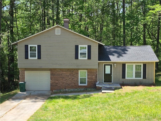 3832 Natalie Way, Ellenwood, GA 30294 - tri-level home featuring brick siding, a chimney, driveway, a front yard, and an attached garage