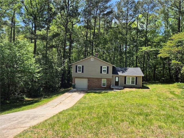 3832 Natalie Way, Ellenwood, GA 30294 - tri-level home with brick siding, driveway, an attached garage, a chimney, and a front yard
