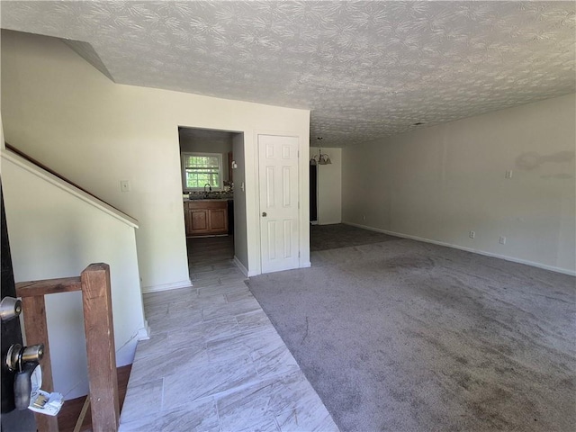 3832 Natalie Way, Ellenwood, GA 30294 - unfurnished living room featuring a sink, a textured ceiling, and baseboards