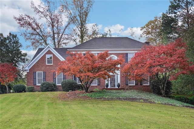 colonial-style house with a front lawn