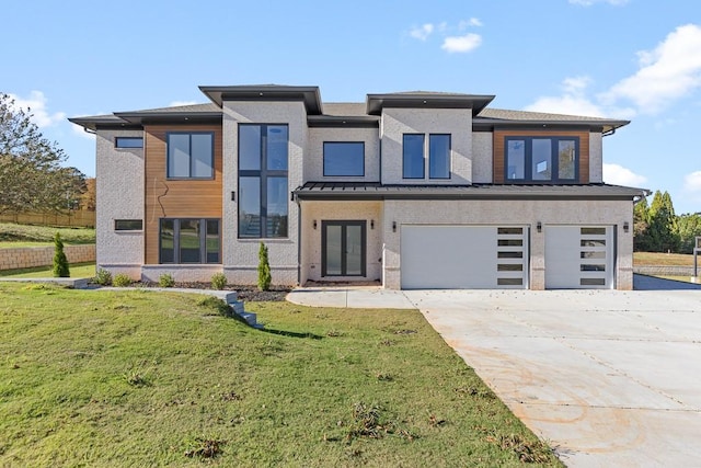 view of front of property with a garage and a front yard