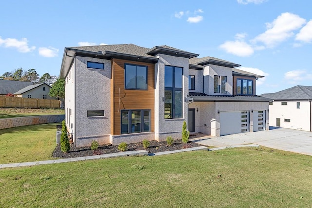 view of front of home featuring a garage and a front yard