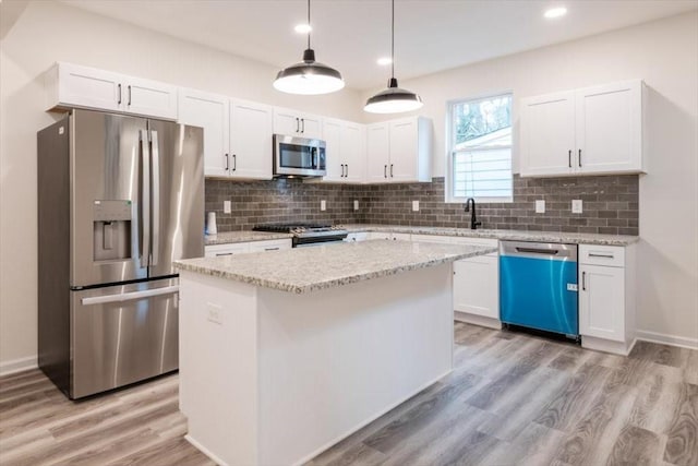 kitchen with a center island, white cabinets, and appliances with stainless steel finishes