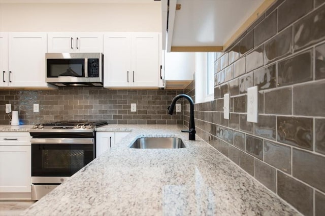 kitchen with sink, stainless steel appliances, and white cabinets