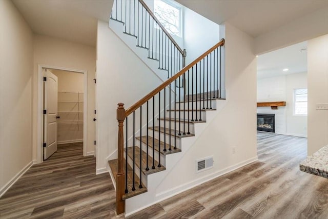 stairway with hardwood / wood-style flooring