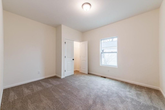 unfurnished bedroom featuring dark carpet