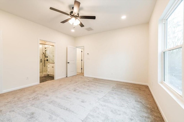 unfurnished bedroom featuring ensuite bathroom, ceiling fan, and carpet