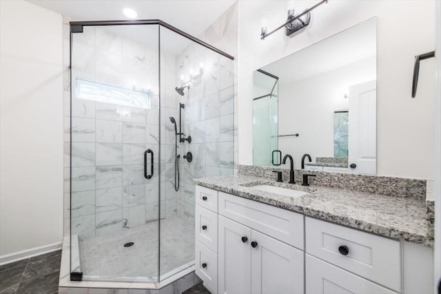 bathroom featuring vanity and a shower with door