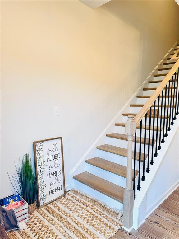 135 Softwood Ct, Dawsonville, GA 30534 - stairway with wood finished floors and baseboards
