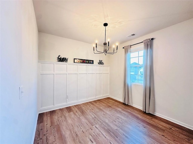 135 Softwood Ct, Dawsonville, GA 30534 - unfurnished dining area featuring a chandelier and wood finished floors