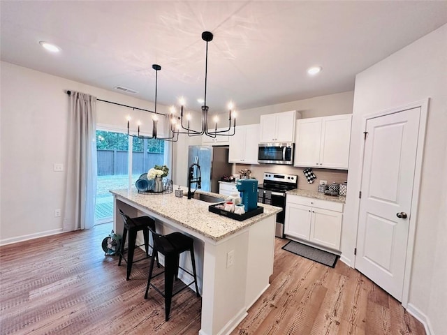 135 Softwood Ct, Dawsonville, GA 30534 - kitchen featuring stainless steel appliances, a chandelier, light wood-type flooring, and recessed lighting