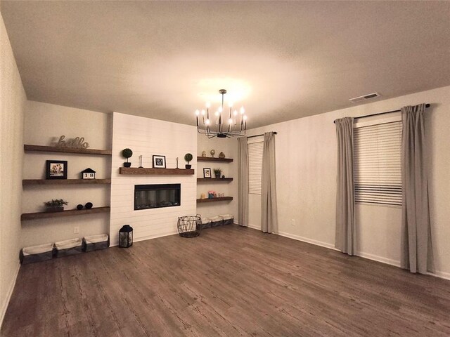 135 Softwood Ct, Dawsonville, GA 30534 - unfurnished living room with a chandelier, dark wood finished floors, and a fireplace