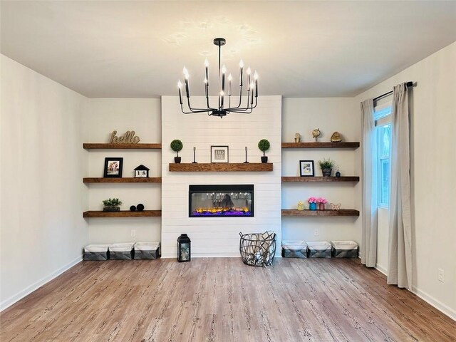 135 Softwood Ct, Dawsonville, GA 30534 - living area featuring a chandelier, wood finished floors, and a fireplace