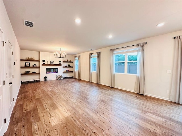 135 Softwood Ct, Dawsonville, GA 30534 - unfurnished living room featuring a chandelier, light wood-style flooring, and recessed lighting