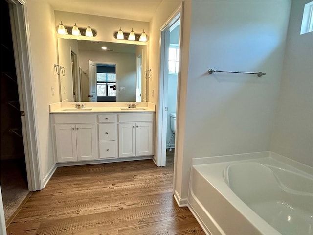 135 Softwood Ct, Dawsonville, GA 30534 - bathroom with a garden tub, double vanity, and wood finished floors