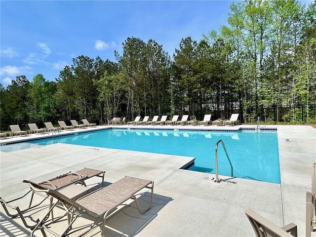 135 Softwood Ct, Dawsonville, GA 30534 - community pool featuring a patio area and view of wooded area